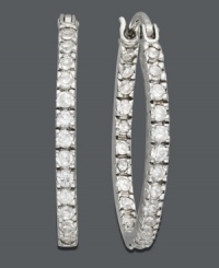 Make your outfit pop with a touch of sparkle. Crafted in sterling silver, oval-shaped hoops by B. Brilliant feature round-cut cubic zirconias (1/2 ct. t.w.). Approximate diameter: 7/8 inch. Make your outfit pop with a touch of sparkle. Crafted in sterling silver, oval-shaped hoops by B. Brilliant feature round-cut cubic zirconias (1/2 ct. t.w.). Approximate diameter: 7/8 inch.