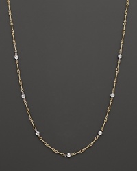 A yellow and white gold necklace with bezel-set diamond stations. With signature ruby accent. Designed by Roberto Coin. A yellow and white gold necklace with bezel-set diamond stations. With signature ruby accent. Designed by Roberto Coin.