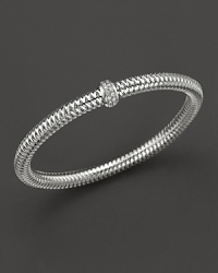 A row of diamonds binds this woven 18K white gold bracelet from Roberto Coin. A row of diamonds binds this woven 18K white gold bracelet from Roberto Coin.